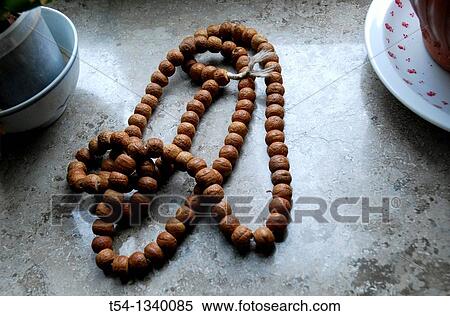 Indian prayer chain is on a window sill View Large Photo Image Stock Photography - Indian prayer chain is on a window sill. Fotosearch
