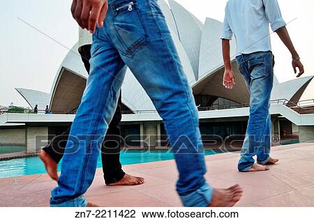 Indian visitors walking barefoot in front of Lotus Temple, India. View Large Photo Image Stock Image - Indian visitors walking barefoot in front of Lotus Temple, India.. Fotosearch