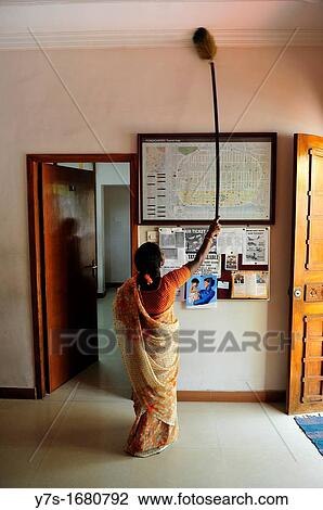 Stock Image - Indian woman cleaning the entrance of guesthouse in Puducherry Pondichery, Tamil Nadu, South India, Asia. Fotosearch