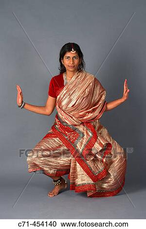 Indian woman in traditional clothing doing traditional dance View Large Photo Image Stock Image - Indian woman in traditional clothing doing traditional dance. Fotosearch