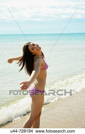 Picture - Indian woman on the beach. Fotosearch