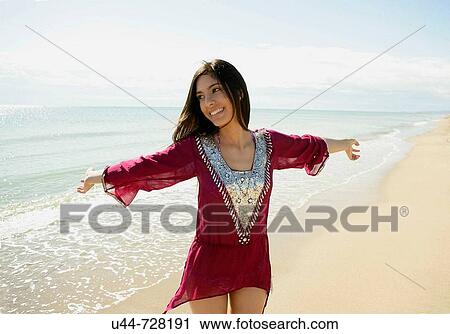 Stock Image - Indian woman on the beach. Fotosearch