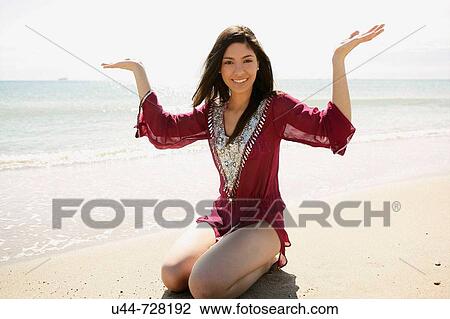 Stock Image - Indian woman on the beach. Fotosearch
