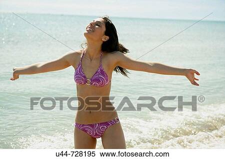Stock Photography - Indian woman on the beach. Fotosearch