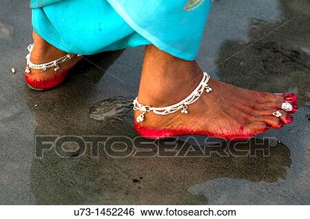 Stock Photograph - Indian woman's feet decorated with anklet and red color.. Fotosearch