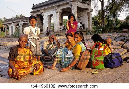 Stock Image - Indian women sitting in front of a temple. Fotosearch