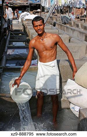 Stock Photography - Indian worker in Mahalaxmi Dhobi Ghat, a huge place where people washes thousends of kilos of clothes everyday. Fotosearch