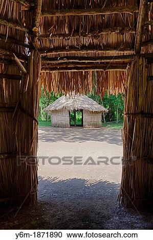 Stock Image - Indigenous tride huts, at Centro Ceremonial Indigena de Tibes, Ponce, Puerto Rico. Fotosearch