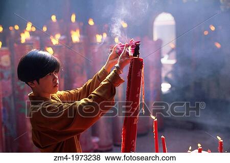 INDONESIA, JAKARTA, GLODOK CHINATOWN, VIHARA DHARMA BHAKTI TEMPLE, YOUNG WOMAN LIGHTING INCENSE. View Large Photo Image Stock Photo - INDONESIA, JAKARTA, GLODOK CHINATOWN, VIHARA DHARMA BHAKTI TEMPLE, YOUNG WOMAN LIGHTING INCENSE.. Fotosearch