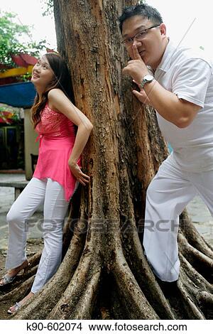 Picture - Indonesian Chinese couple together playing Hide and Seek, Jakarta, Indonesia, Southeast Asia. Fotosearch