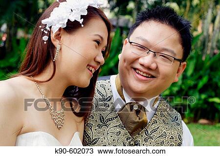 Stock Image - Indonesian Chinese wedding couple being happily together, Jakarta, Indonesia, Southeast Asia. Fotosearch