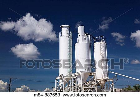 Stock Image - Industrial cement mixing, storage and distribution tanks at a cement making facility, Montreal, Quebec, Canada. Fotosearch