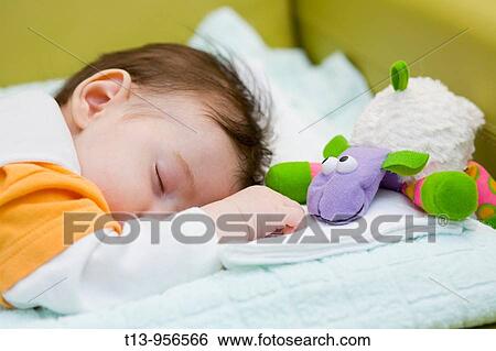 Infant baby is taking a nap View Large Photo Image Stock Photograph - Infant baby is taking a nap. Fotosearch