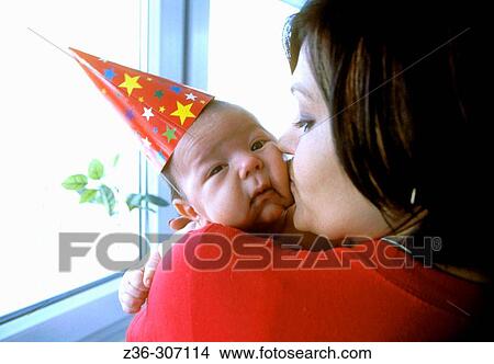 Infant boy in New Year hat with mother View Large Photo Image Picture - Infant boy in New Year hat with mother. Fotosearch