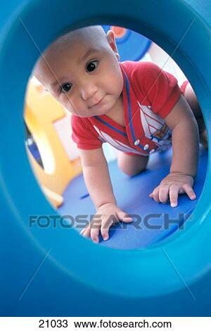 Infant boy playing on plastic playground View Large Photo Image Stock Image - Infant boy playing on plastic playground. Fotosearch