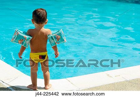 Infant boy standing by a pool View Large Photo Image Stock Image - Infant boy standing by a pool. Fotosearch