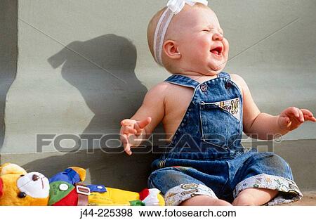 Infant girl sitting and laughing outdoor View Large Photo Image Stock Photo - Infant girl sitting and laughing outdoor. Fotosearch