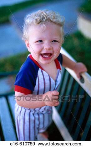 Stock Photo - Infant on bench. Fotosearch