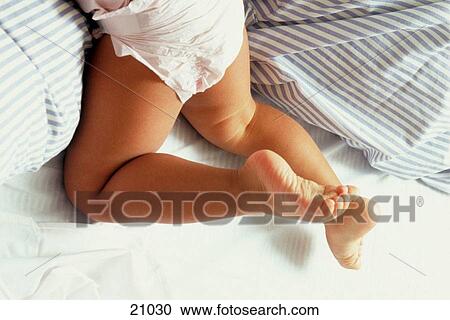 Infant's legs on a bed View Large Photo Image Stock Image - Infant's legs on a bed. Fotosearch