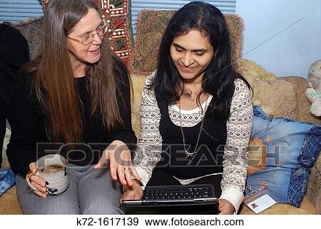 Informal businesswomen reviewing ideas View Large Photo Image Stock Photo - Informal businesswomen reviewing ideas. Fotosearch