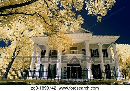 Stock Image - Infrared photography of the Exterior view of a Victorian era home, 1887, Calvert, Texas. Fotosearch