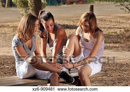 injured girl doing sport, helped by her friends View Large Photo Image Stock Image - injured girl doing sport, helped by her friends. Fotosearch