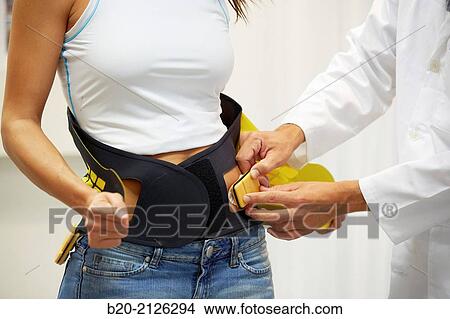 Innovative belt against back pain. View Large Photo Image Picture - Innovative belt against back pain.. Fotosearch