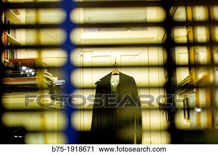 Stock Image - inside view of an office from a window with blind. Fotosearch