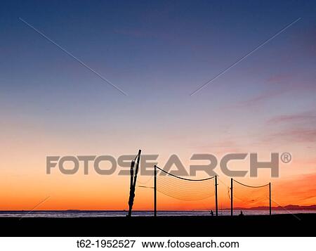 Stock Photo - Installing beach volleyball, a winter sunset.. Fotosearch