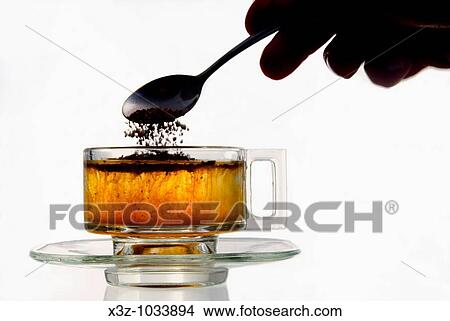 Instant coffee added to water in a glass cup View Large Photo Image Picture - Instant coffee added to water in a glass cup. Fotosearch