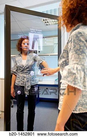 Interactive mirror that allows the person standing in front of it to see a simulated view of how the clothes they wish to buy would look when they wear them without trying the clothes on, Internet of Things lab, Tecnalia Research & Innovation View Large Photo Image Stock Image - Interactive mirror that allows the person standing in front of it to see a simulated view of how the clothes they wish to buy would look when they wear them without trying the clothes on, Internet of Things lab, Tecnalia Research & Innovation. Fotosearch