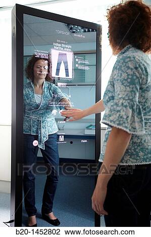 Interactive mirror that allows the person standing in front of it to see a simulated view of how the clothes they wish to buy would look when they wear them without trying the clothes on, Internet of Things lab, Tecnalia Research & Innovation View Large Photo Image Stock Image - Interactive mirror that allows the person standing in front of it to see a simulated view of how the clothes they wish to buy would look when they wear them without trying the clothes on, Internet of Things lab, Tecnalia Research & Innovation. Fotosearch