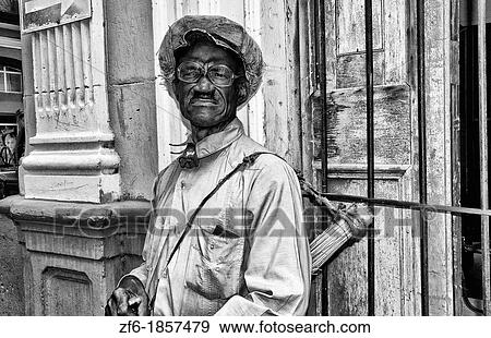 Interesting man with music instr5ument on corner of Cardenas Cuba View Large Photo Image Stock Photo - Interesting man with music instr5ument on corner of Cardenas Cuba. Fotosearch