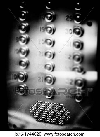 Stock Image - Interfono con numeros de edificio de pisos, Intercom with numbers in apartment building.. Fotosearch