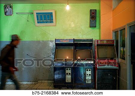 Picture - Interior of a Caf? -Bar with gaming machines and a unrecognizable customer in movement. Morocco, Africa.. Fotosearch