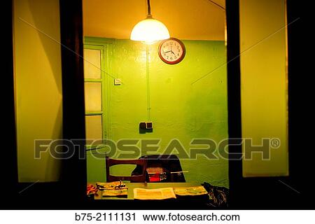 Interior of an office with a desk, a wall clock and a lamp lit in the ceiling. Barcelona, Spain, Europe. View Large Photo Image Stock Image - Interior of an office with a desk, a wall clock and a lamp lit in the ceiling. Barcelona, Spain, Europe.. Fotosearch