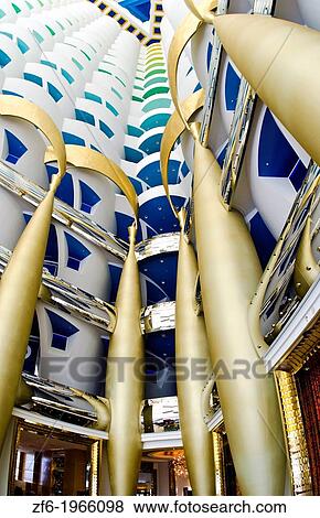 Stock Photo - Interior of pillars abstract in the worlds only 7 star hotel the Burj Al Arab in Dubai in UAE where the economy and money is thriving in the United Arab Emirates.. Fotosearch