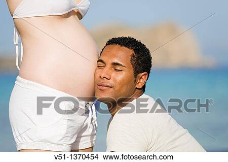 Interracial couple at the beach View Large Photo Image Picture - Interracial couple at the beach. Fotosearch
