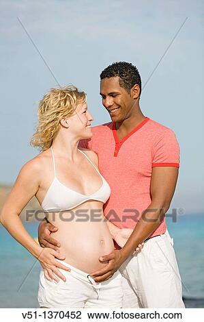 Interracial couple at the beach View Large Photo Image Stock Image - Interracial couple at the beach. Fotosearch