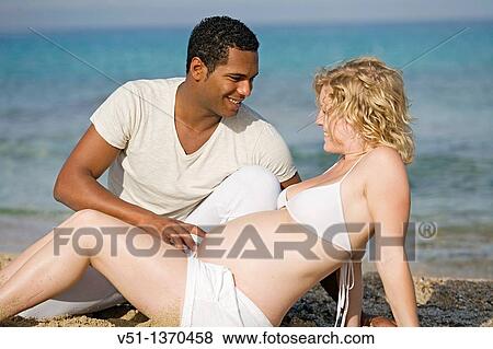 Interracial couple at the beach View Large Photo Image Stock Photo - Interracial couple at the beach. Fotosearch
