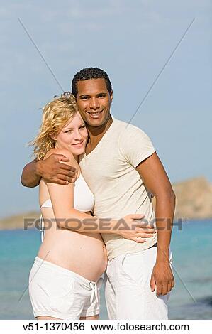 Interracial couple at the beach View Large Photo Image Stock Photograph - Interracial couple at the beach. Fotosearch