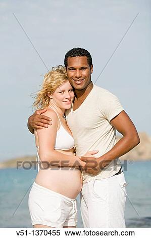 Interracial couple at the beach View Large Photo Image Stock Photography - Interracial couple at the beach. Fotosearch