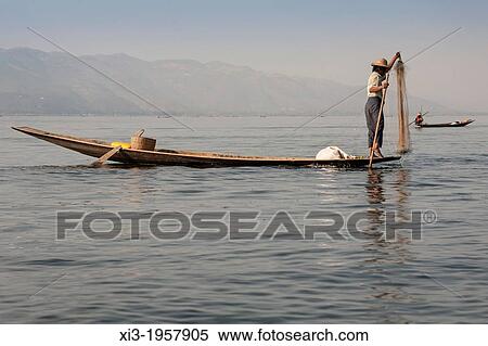 Intha fisherman fishing in a traditional fishing boat, Inle Lake, Nyaung Shwe, Shan State, Myanmar, (Burma). View Large Photo Image Stock Photography - Intha fisherman fishing in a traditional fishing boat, Inle Lake, Nyaung Shwe, Shan State, Myanmar, (Burma).. Fotosearch