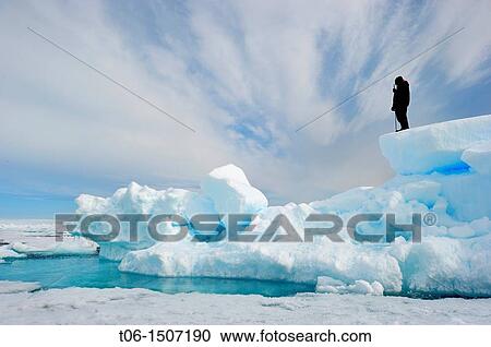 Inuit guide observing melting ice, Floe edge, Arctic Bay, Baffin Island, Nunavut, Canada View Large Photo Image Stock Image - Inuit guide observing melting ice, Floe edge, Arctic Bay, Baffin Island, Nunavut, Canada. Fotosearch