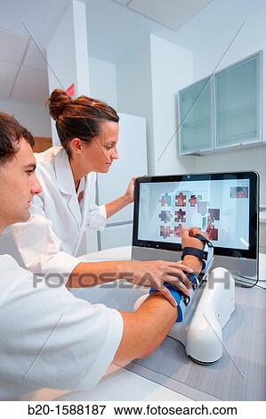 Investigator and patient with assistive robot for upper limb rehabilitation at home View Large Photo Image Stock Photo - Investigator and patient with assistive robot for upper limb rehabilitation at home. Fotosearch