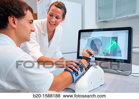 Investigator and patient with assistive robot for upper limb rehabilitation at home View Large Photo Image Stock Photo - Investigator and patient with assistive robot for upper limb rehabilitation at home. Fotosearch