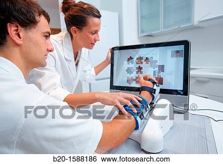 Investigator and patient with assistive robot for upper limb rehabilitation at home View Large Photo Image Stock Photograph - Investigator and patient with assistive robot for upper limb rehabilitation at home. Fotosearch