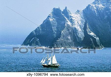 Irish Navy sail training ship Asgard II seen from Skellig Michael island Little Skellig gannet colony behind Kerry, Ireland View Large Photo Image Picture - Irish Navy sail training ship Asgard II seen from Skellig Michael island Little Skellig gannet colony behind Kerry, Ireland. Fotosearch