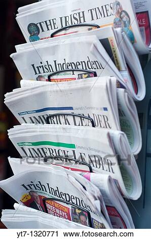 Stock Image - Irish newspapers outside a newsagents shop in Limerick, Republic of Ireland. Fotosearch