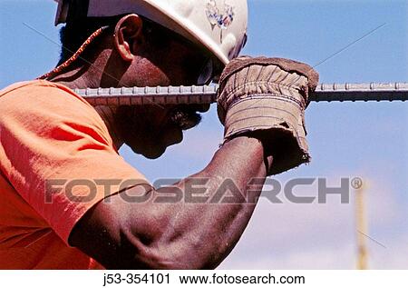 Ironworker carrying long rebar. I-880 Cypress project. Oaklnad, California. USA. View Large Photo Image Stock Image - Ironworker carrying long rebar. I-880 Cypress project. Oaklnad, California. USA.. Fotosearch